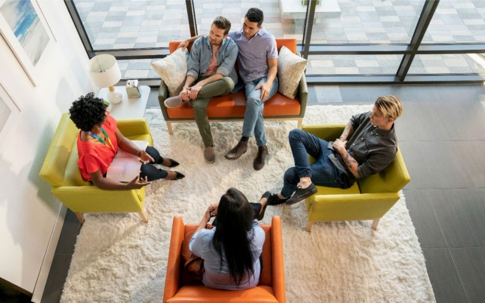 Group of adults seated in armchairs during counseling discussion session