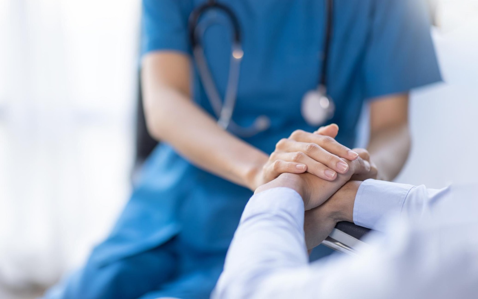 Doctor holding the hands of a patient