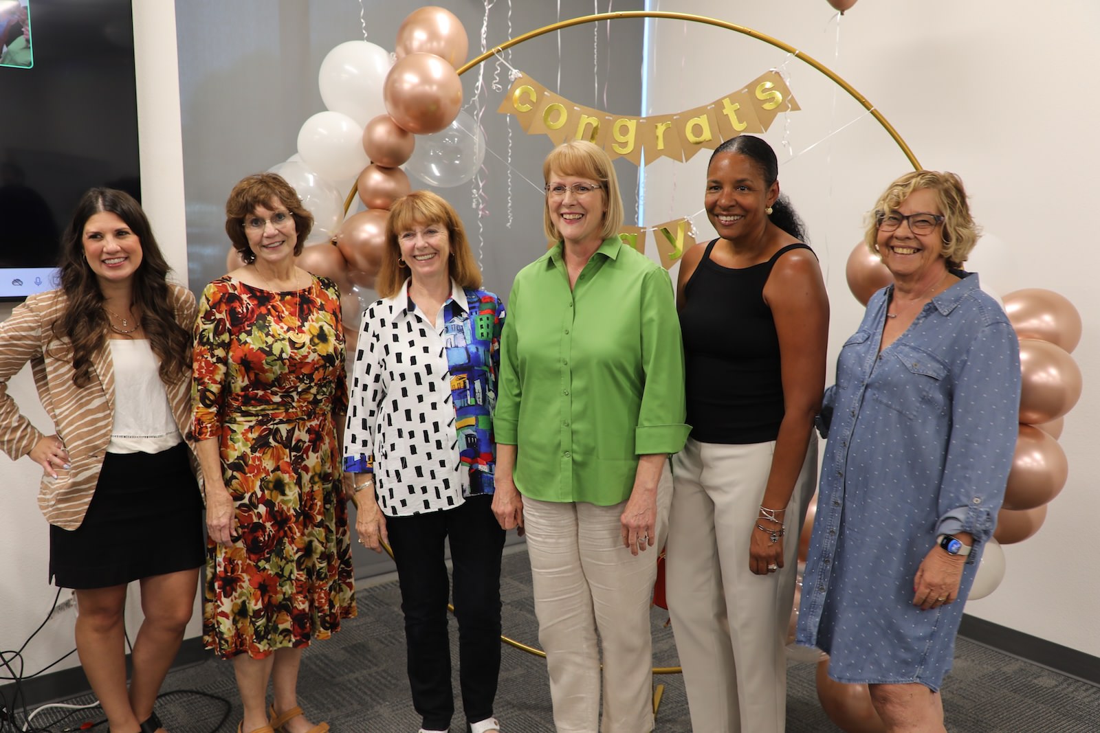 Kay Ruhstaller posing with past Athena award recipients