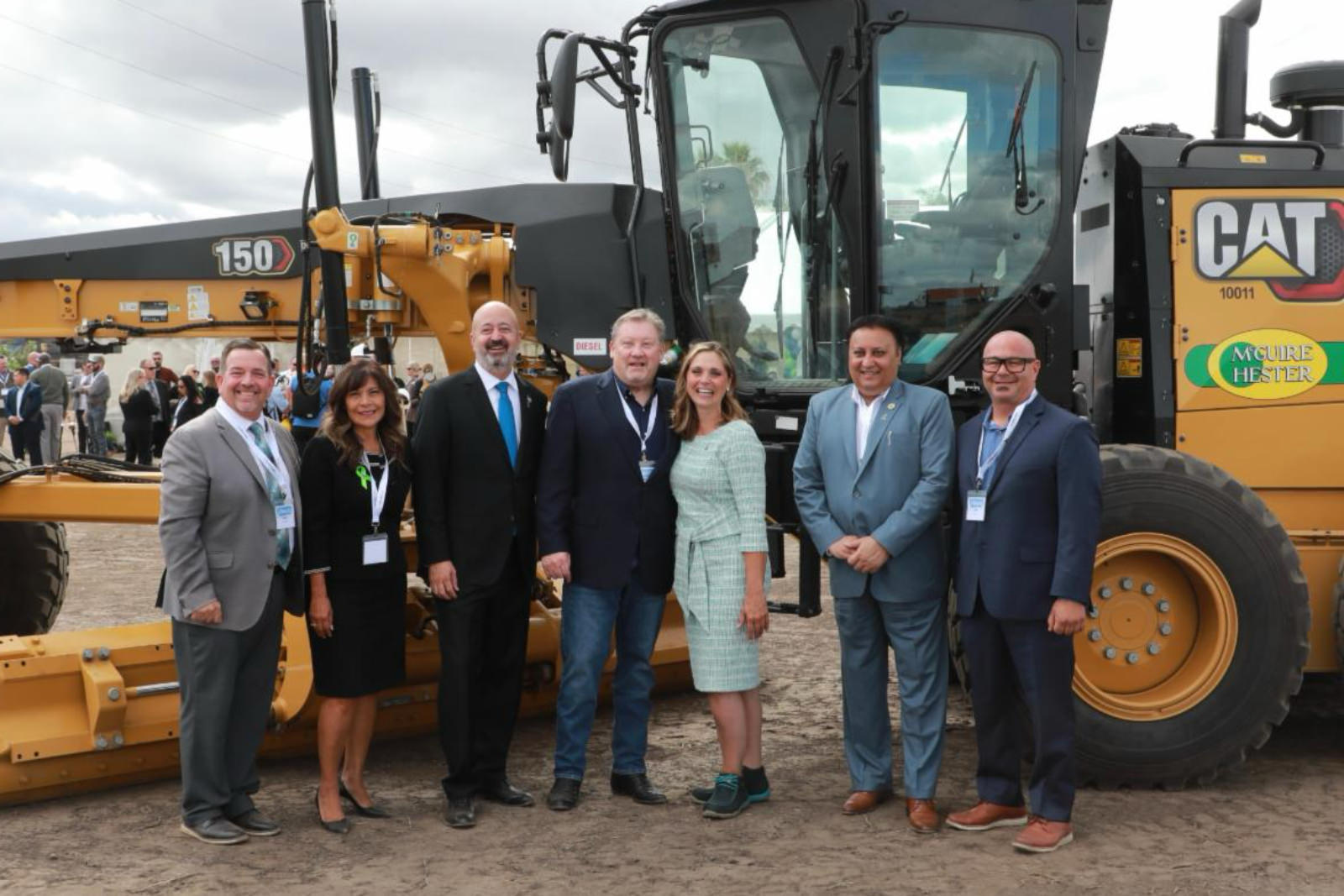 San Joaquin County Board standing in front of tractor
