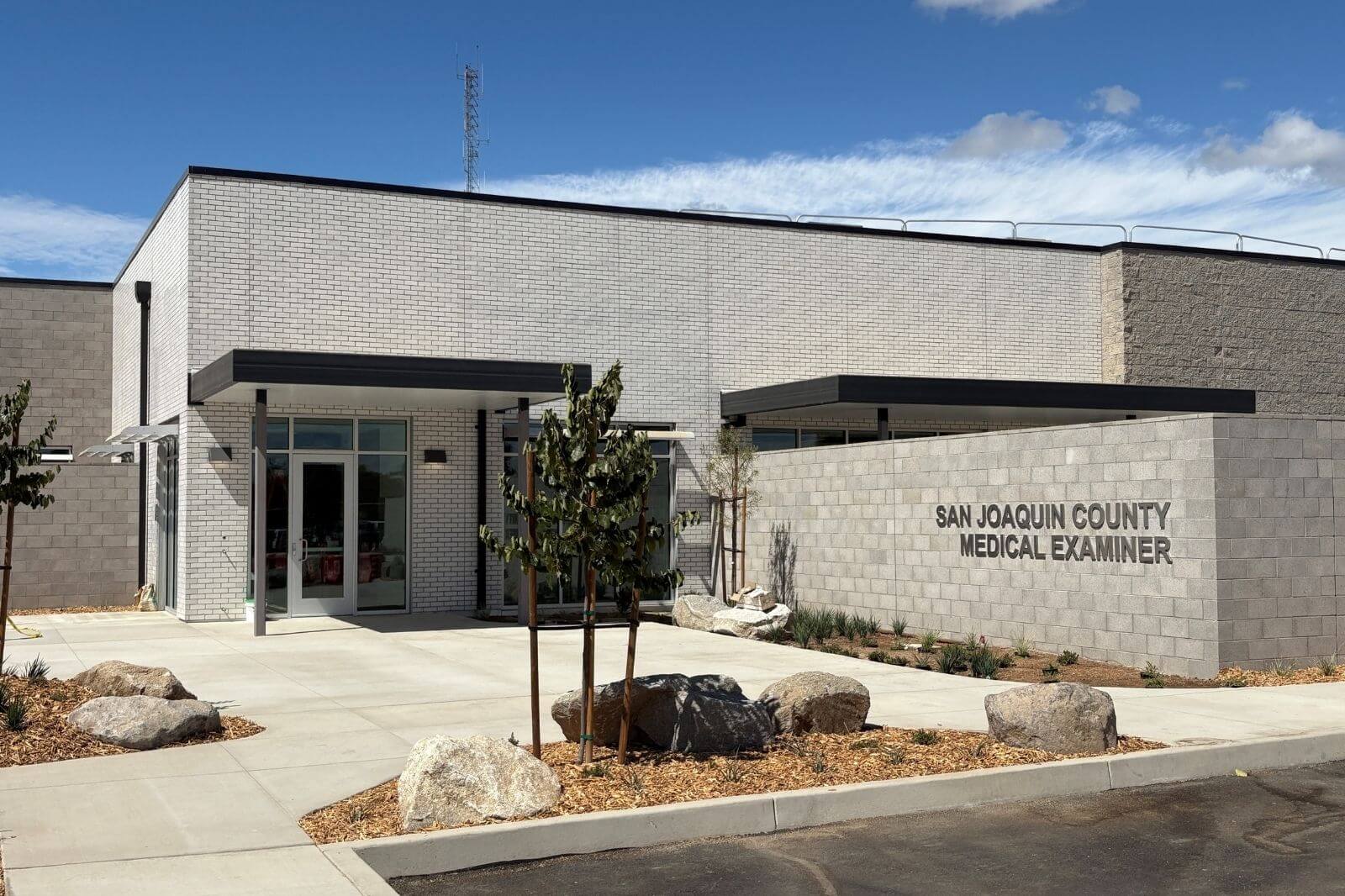 Exterior of San Joaquin County Medical Examiner facility under clear blue sky